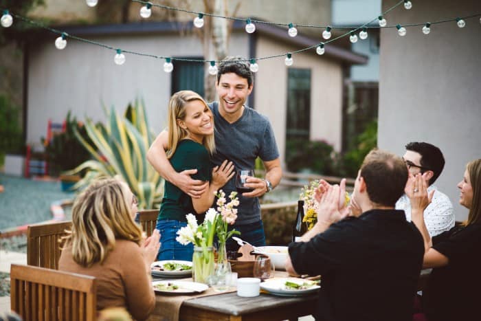 Couple toasting with friends at dinner