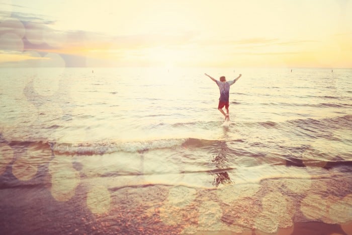 Boy happily playing by the shore