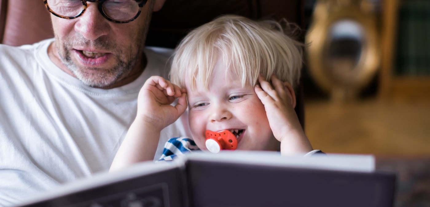 Grandfather reading to his grandson