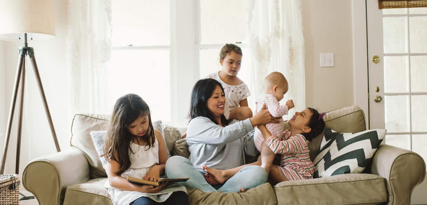 Happy family in the living room not worried about debts