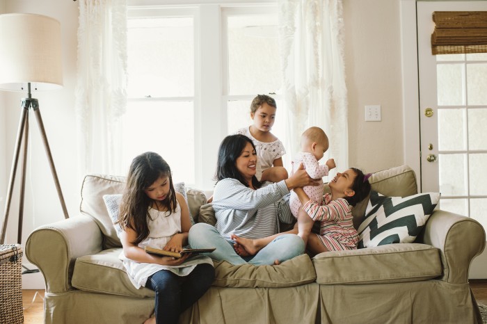 Happy family in the living room not worried about debts