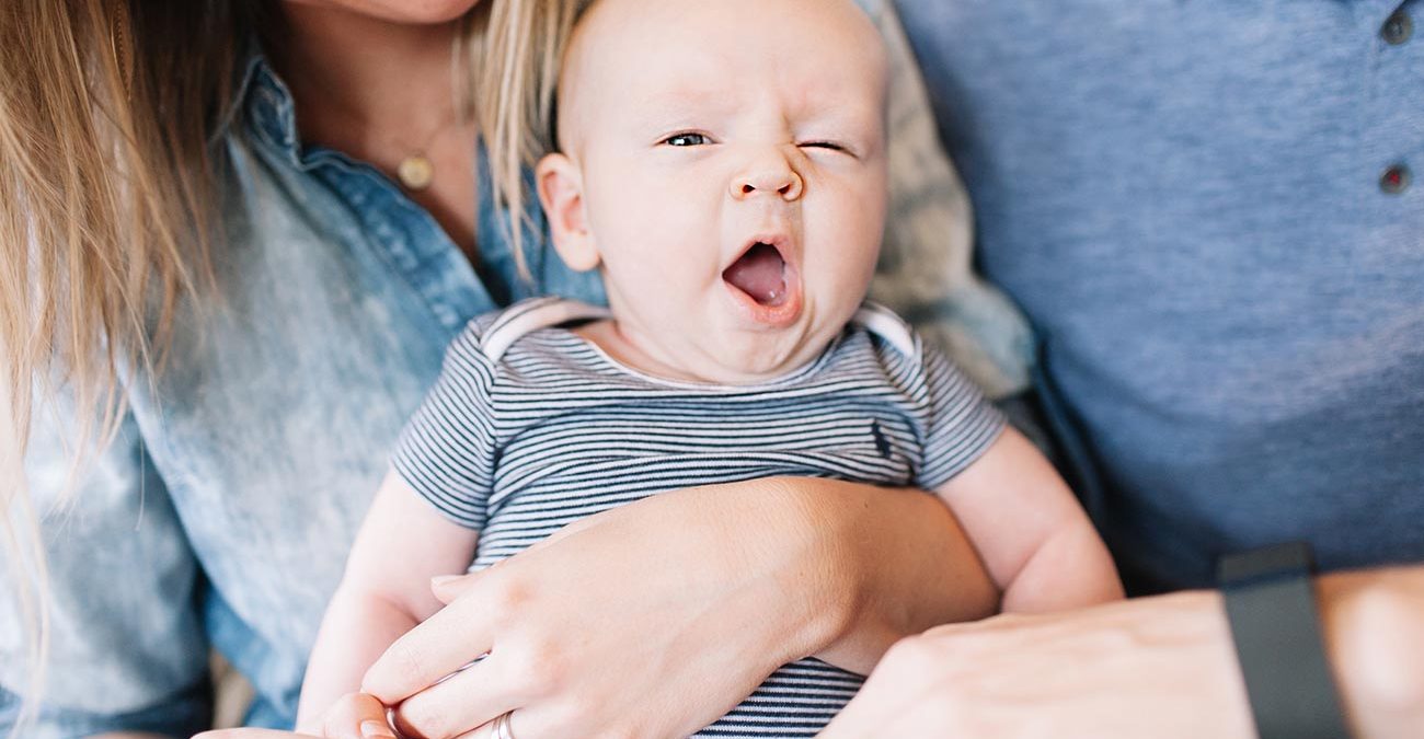 Young family with baby yawning in the middle