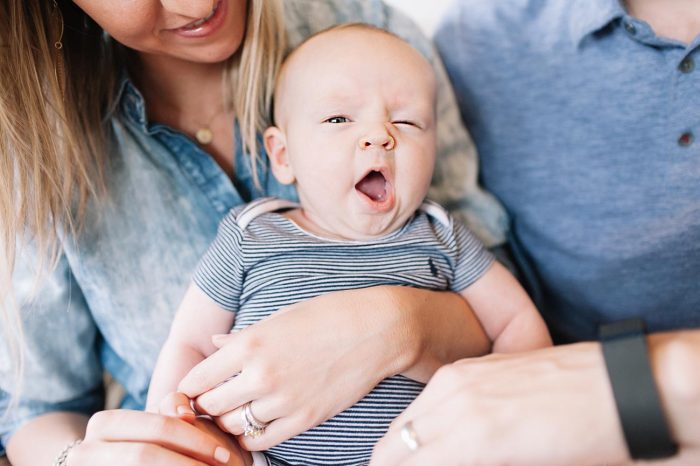 Young family with baby yawning in the middle