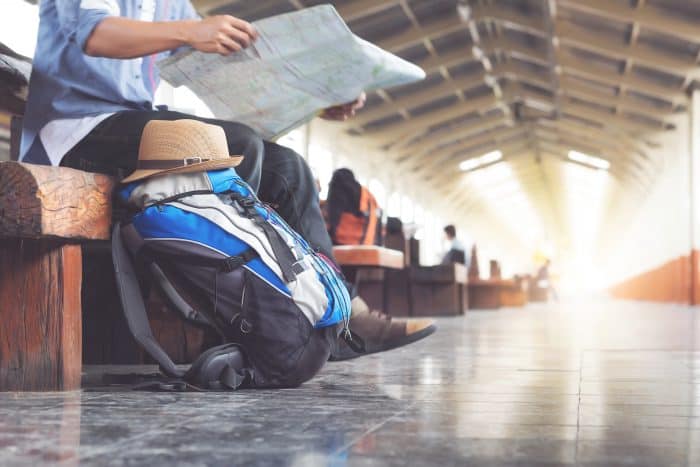 Backpack and hat at the train station with a traveler