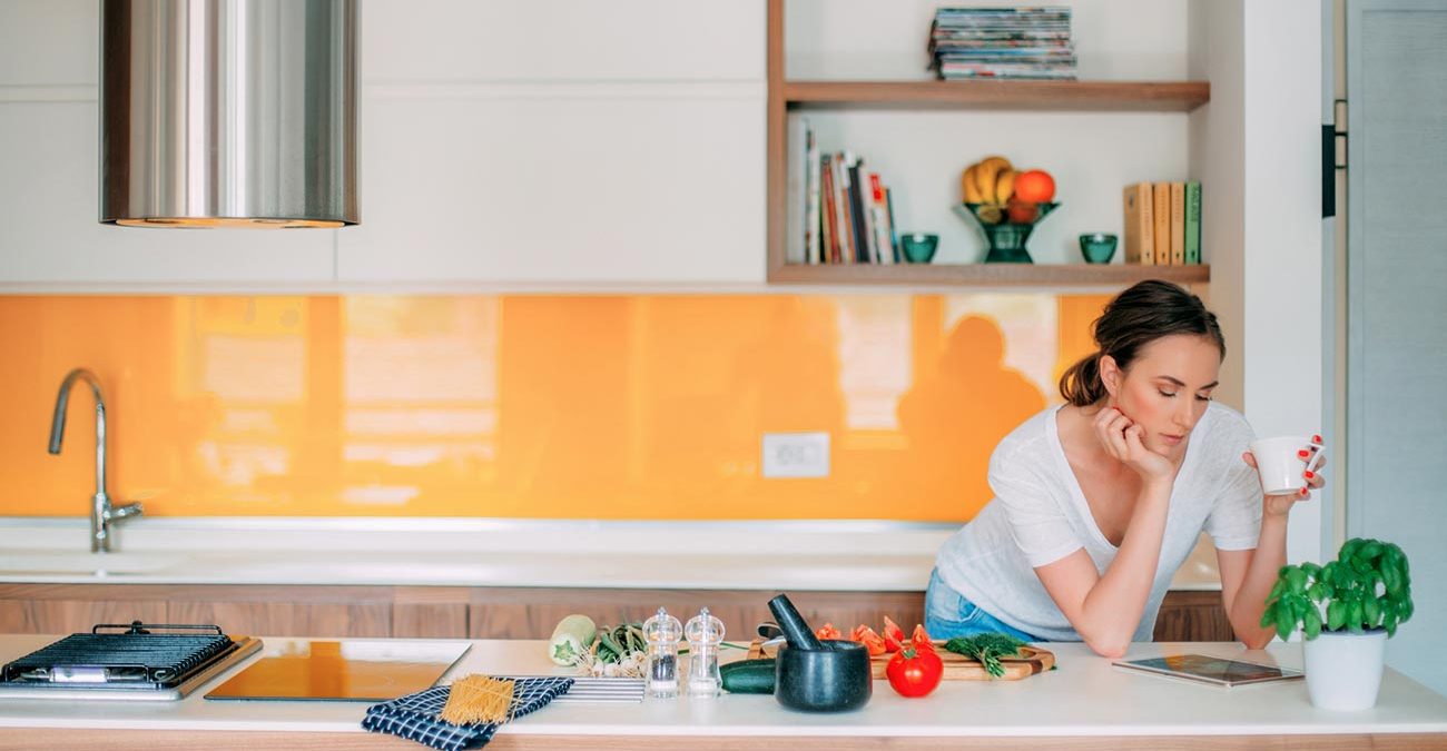 Woman reading in her kitchen