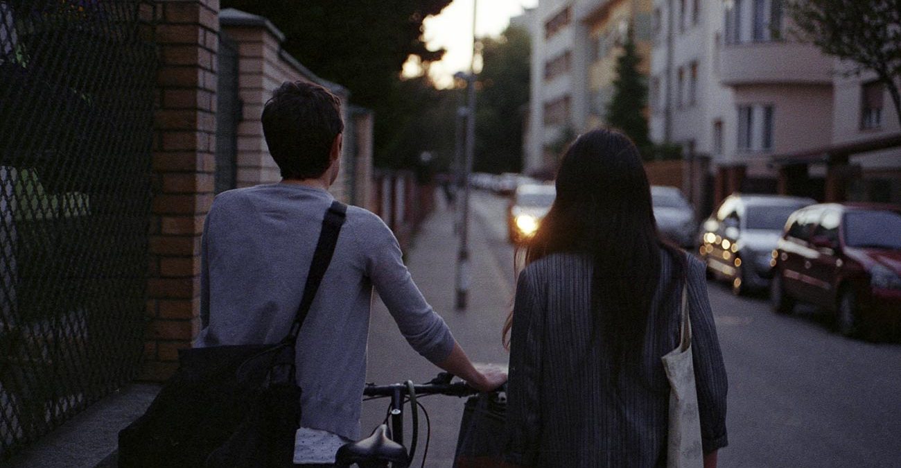 Couple on the street with a bike