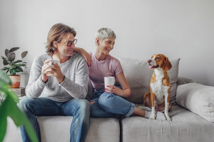 man, woman and dog on the couch