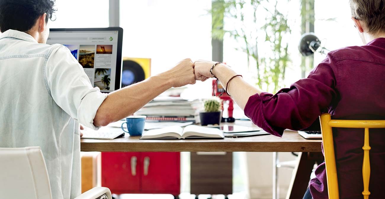 Fist bump colleagues teamwork