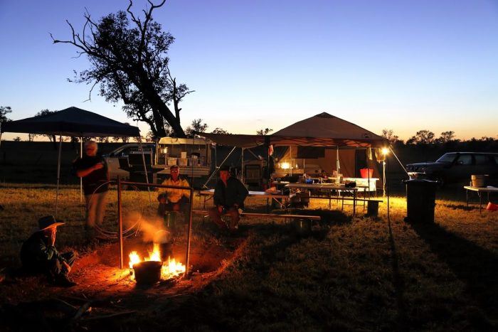 Campers gathered around a campfire