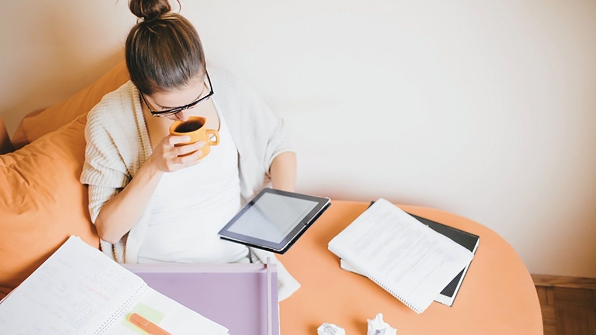 young woman on couch working