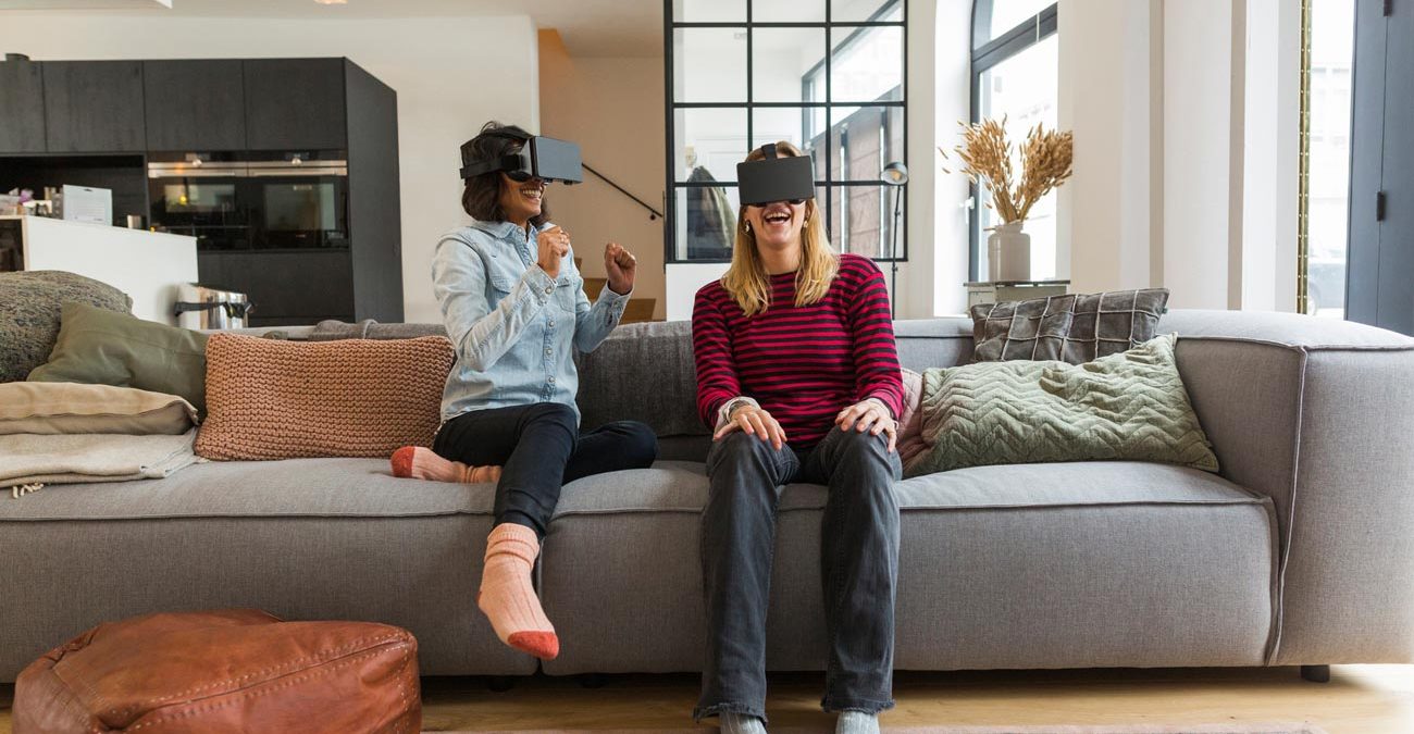 Women playing with VR glasses