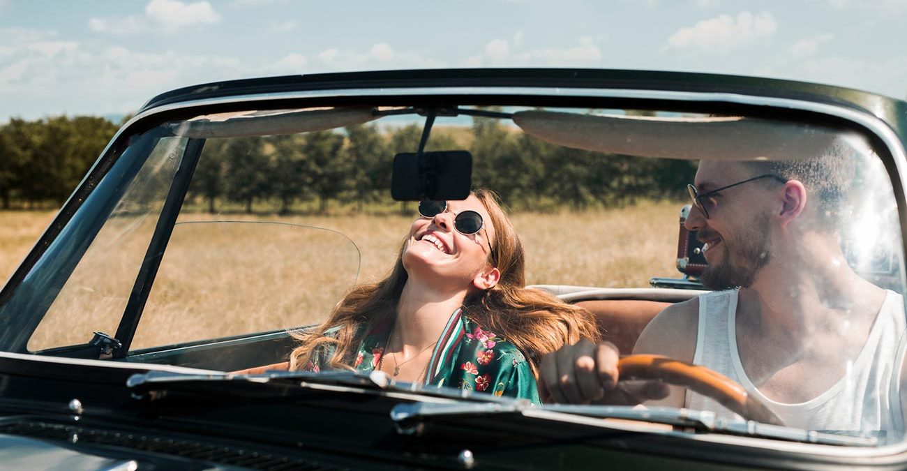 Couple in Love Driving in Convertible Car