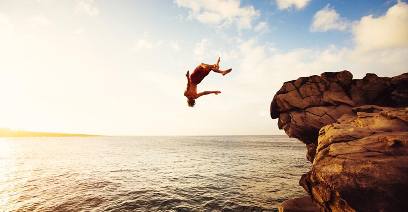 man back dive off rocks