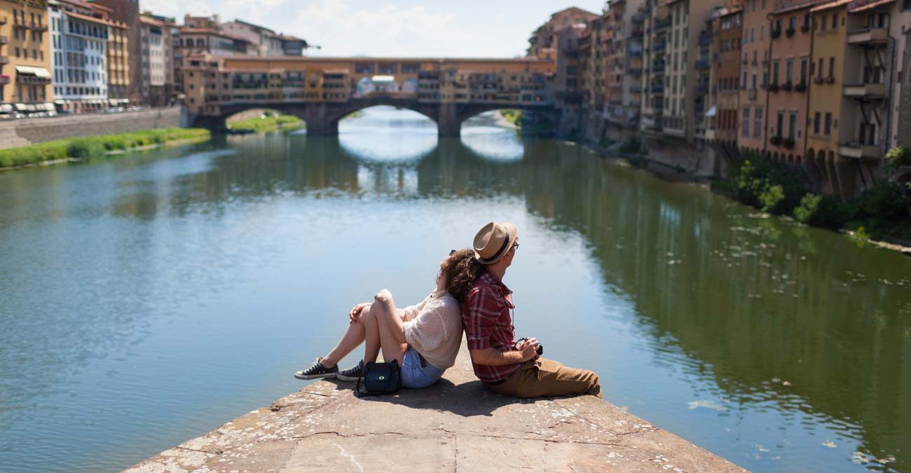 young travellers overlooking Ponte Vecchio in Florence Tuscany Italy