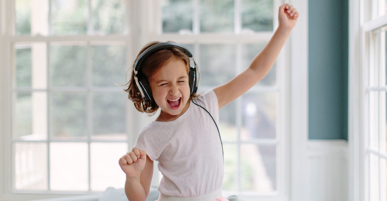 young girl listening to music on headphones