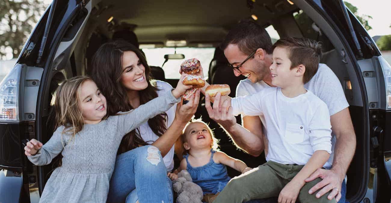 happy Family eating donuts in car