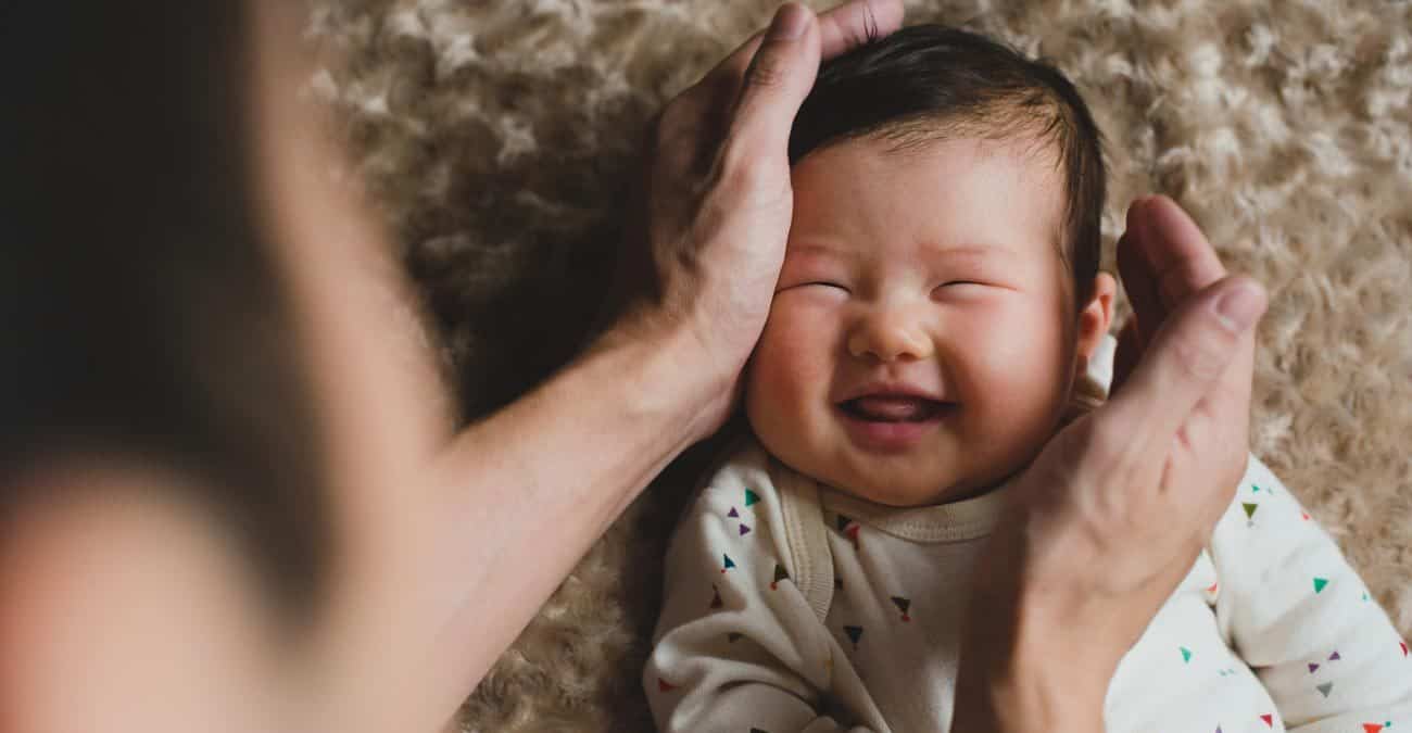 Dad with happy newborn baby