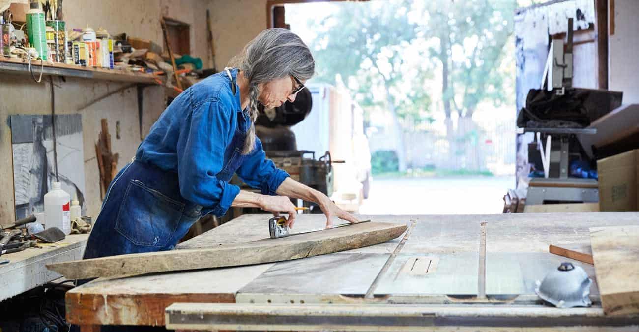 Portrait of senior woman inside her wood shop