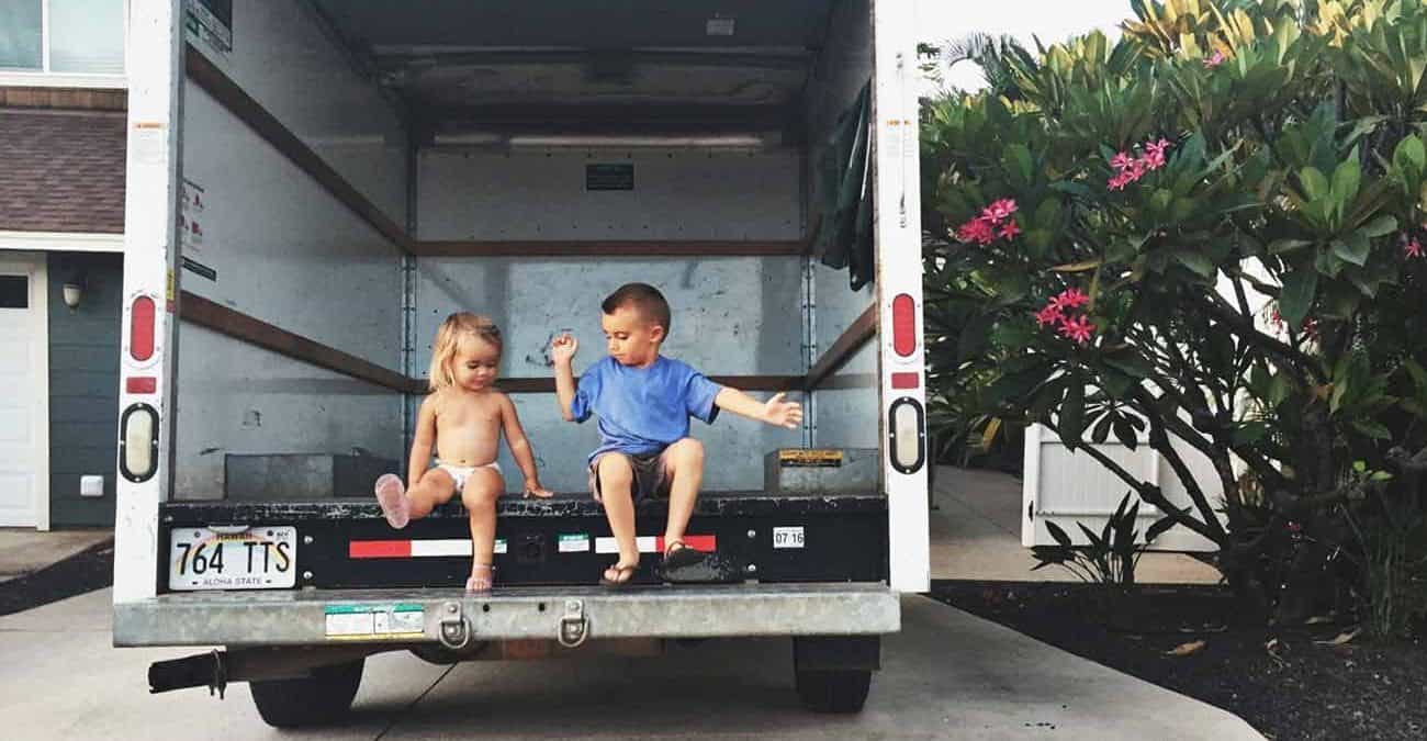 little kids playing inside a moving van