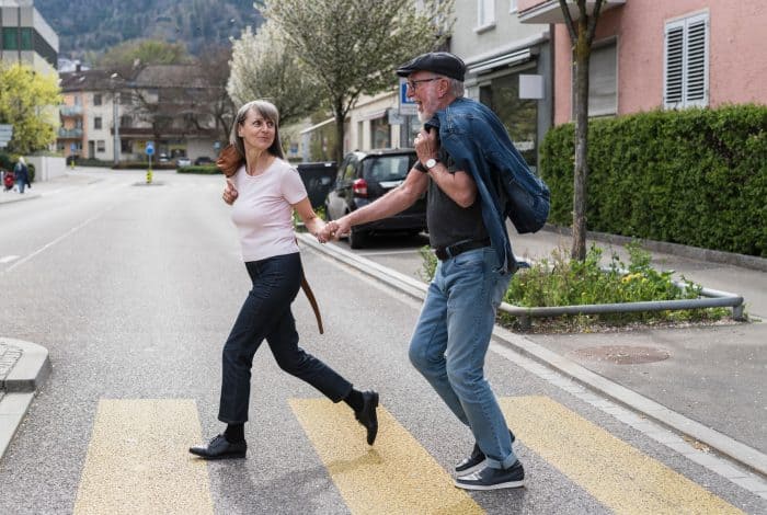 investblue -Senior couple walking on the street in the city.