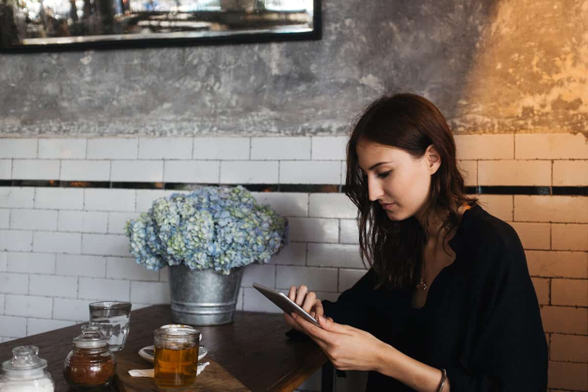 girl using a tablet sitting