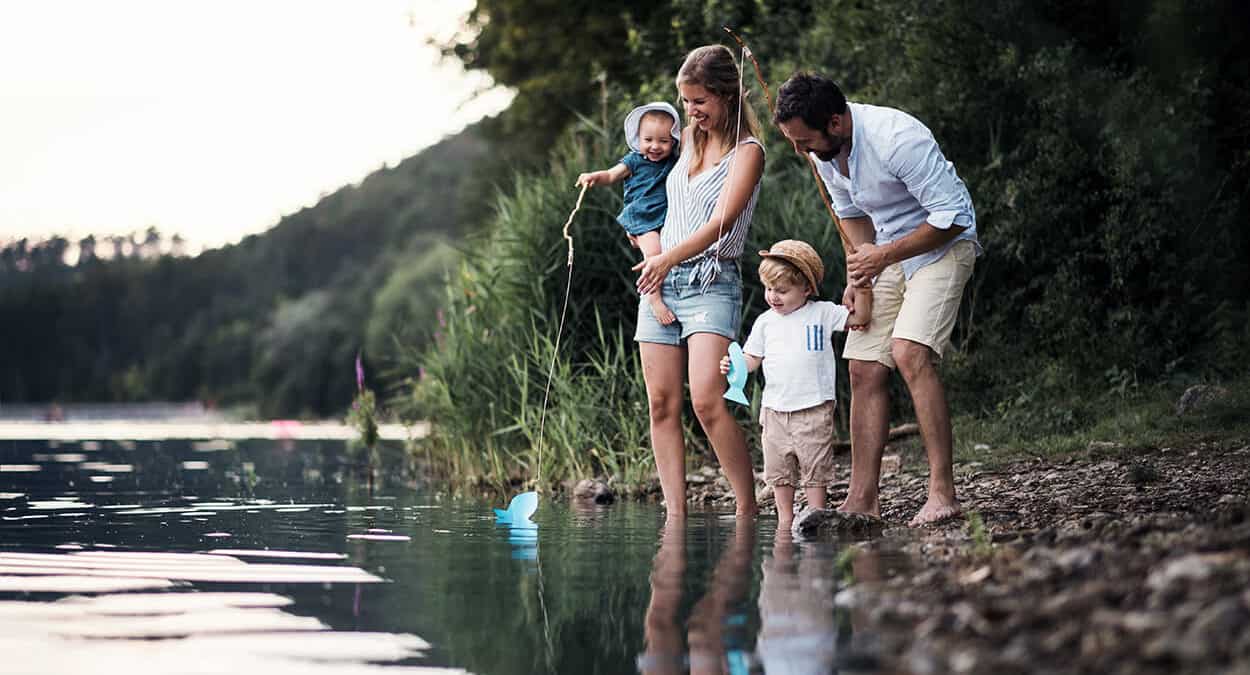 young family playing at the beach